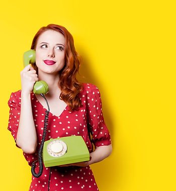 Woman in red holding rotary phone
