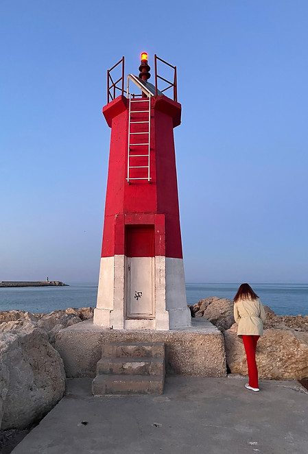 red-lighthouse-at-the-port-with-a-woman-in-red-2021-09-04-09-23-18-utc.jpeg