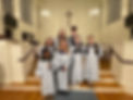 Mallet ringers holding handbells in the sanctuary