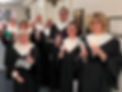 Chancel choir members holding candels in the church