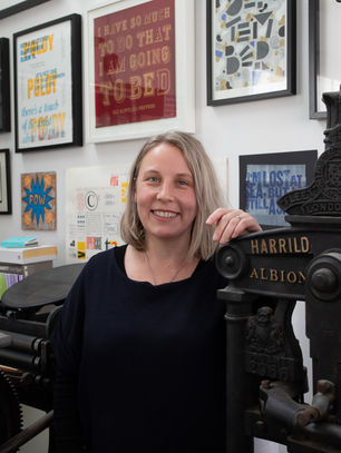 Nicole leaning on her press