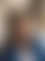 Adrienne in front of her paintings