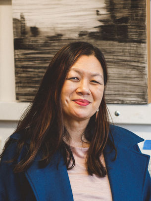 Adrienne in front of her paintings