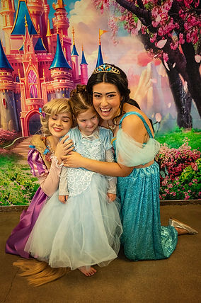 priness rapunzel and jasmine hug at birthday party