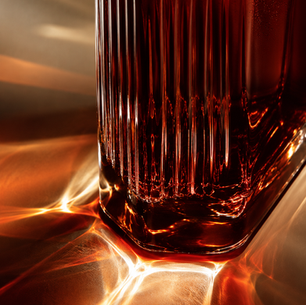 Warm amber coffee fruit cascara tea infusion in clear glass cups featuring glowing backlight and rich reddish brew tones.