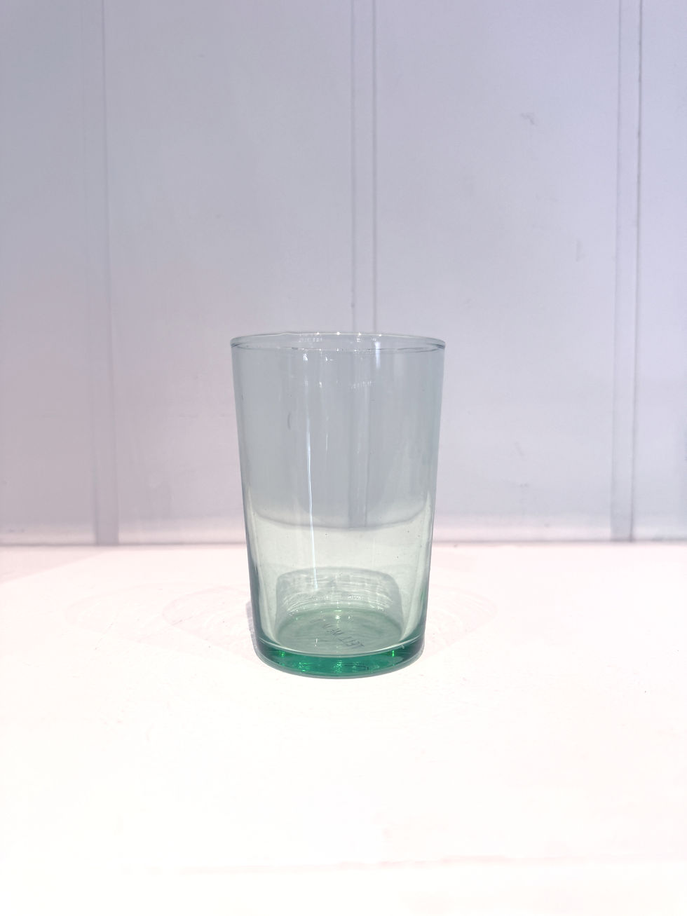 Green glass tumblers with soft green hue and handmade character.