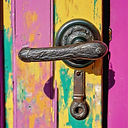 a door handle on a bright coloured door.