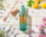 Professional drink photography of Silent Pool Gin bottle styled in a spring garden scene at our Bristol studio.