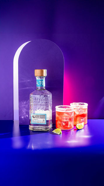 product shoot for an alcohol brand, shot against a purple background, in house at a product photography studio