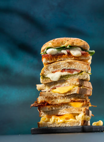 Stack of sandwiches photographed by UK food photographer, in location studio in Bristol, melting cheese, cheese pull
