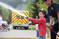 child happy firefighter water.jpg