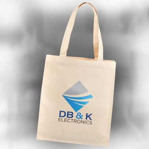 A light-colored tote bag with the logo 'DB&K' printed on it.