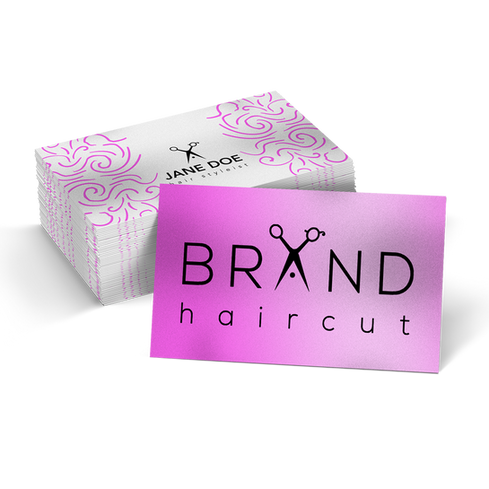 Business cards with a pink gradient background and haircut branding featuring scissors.