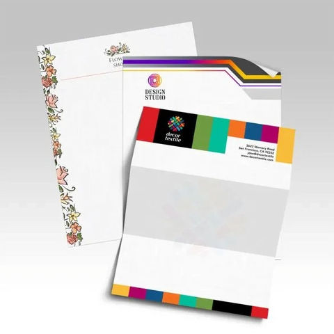 Custom letterhead sheets and matching envelopes with a colorful geometric border and printed company logo.
