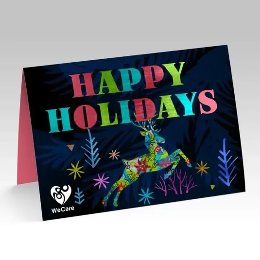 Folded holiday card with “Happy Holidays” in multicolor letters and confetti-style accents on a dark background