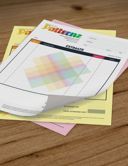 Three‑part full‑color NCR form set with white, yellow, and pink pages fanned out on a wooden desk, displaying a multicolor header and form fields.
