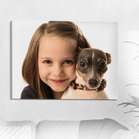 Canvas print of a smiling girl holding her puppy, mounted on a white wall.