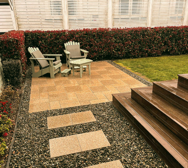 New paved patio and steppers for outdoor seating area. Kwila decking and ornamental hedge.