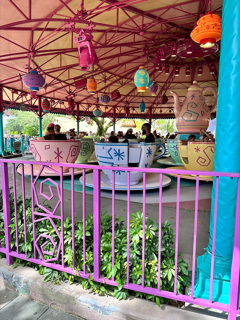 Family using the My Disney Experience app to book dining and Lightning Lane reservations- Tea Cups