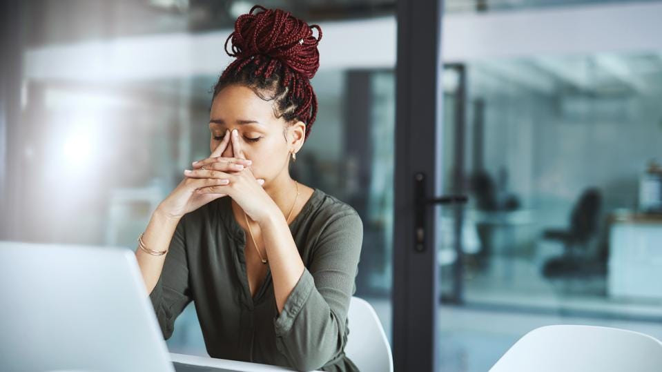 A woman working and feeling anxiety. High Functioning anxiety therapy in st. louis mo. Marble Wellness is a therapy practice offering counseling services for anxiety, depression and more.