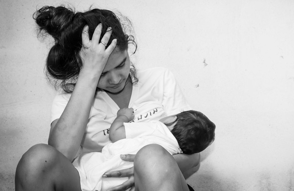 A new mom who looks and feels overwhelmed with motherhood. She is feeling maternal overwhelm and dealing with postpartum depression. Marble Wellness is a therapy practice that specializes in Maternal Mental Health and maternal overwhelm along with much more like anxiety, depression, couples counseling and more! marble Wellness is located in Ballwin, Mo 63011,