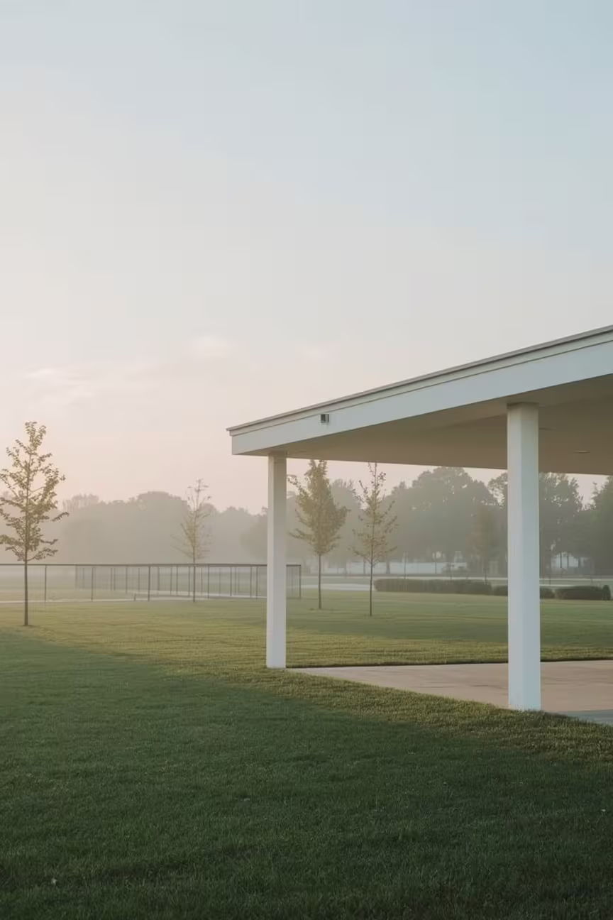 A Photo of the Pavilion at Congressman Bill Archer Dog Park with the open Fields in the background set in the early morning. 