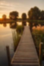 A Photo of Keith Weiss Park's Dock for the Pond with trees in the background. 