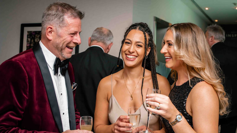 Birthday guest laughing with family during his 60th birthday party in Manchester.