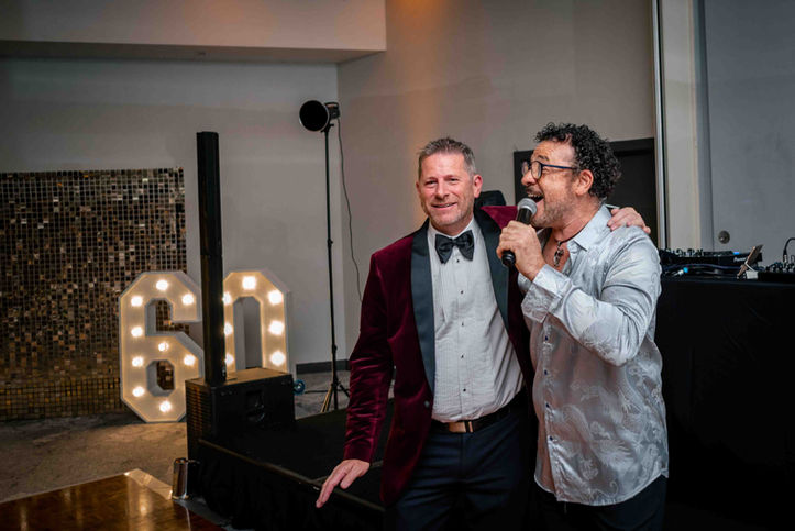 Birthday guest joining the live entertainer during his 60th celebration at The Lowry Hotel.