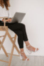 photo of woman sitting in a chair with a laptop on her lap