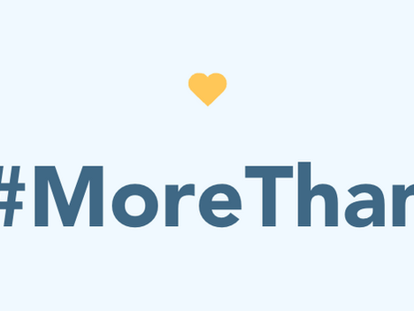 Blue text "#MoreThan" with a yellow heart above, set against a light blue background, conveying a positive mood.