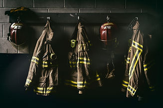 Firefighter hanging suit in a dark room.jpg