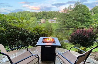 Outdoor fire pit with a view at this Airbnb in Boone, NC.