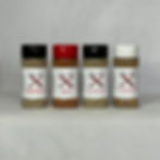 Four Clear bottles of Brand X Seasoning mix with black lid and white branded label