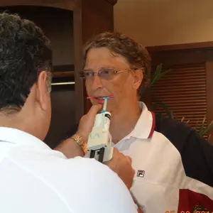 Dr. Allen Nazeri taking a dental bite on Mr. Bill Gates