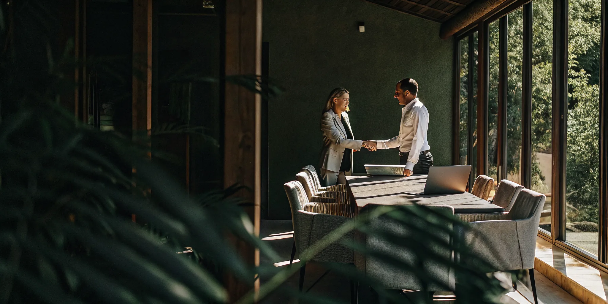 Healthcare practice owner and M&A advisor reviewing sale documents at an office table