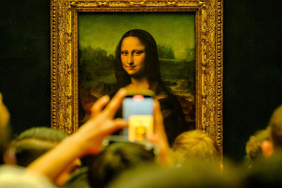 A crowd taking pictures of the Mona Lisa at the Louvre