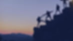 a picture of mountain climbers helping each other summit