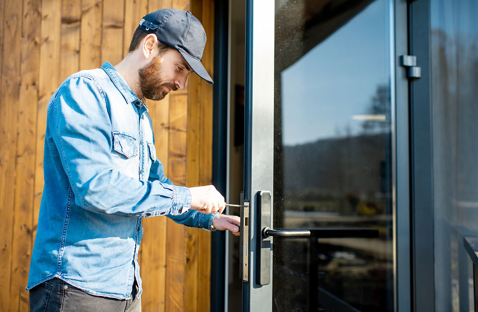 man-repairing-door-lock-2021-11-01-22-22-18-utc.jpg