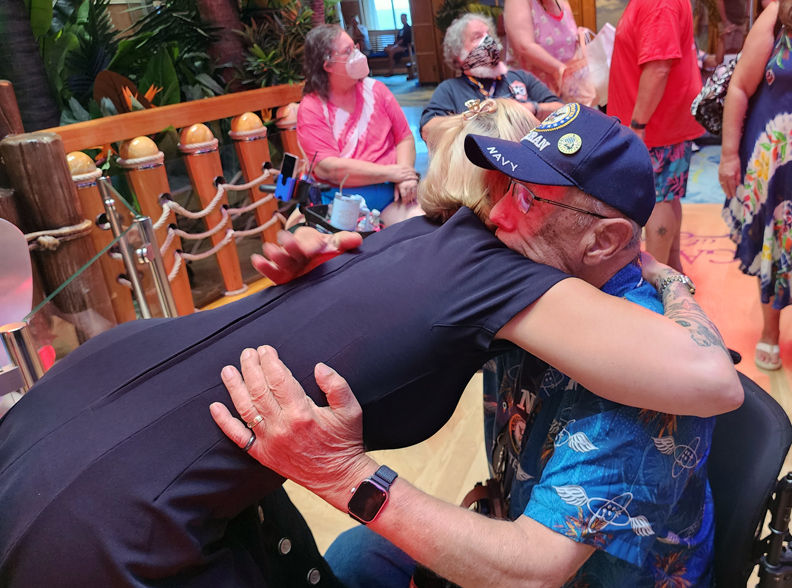 Woman hugging military veteran in wheelchair