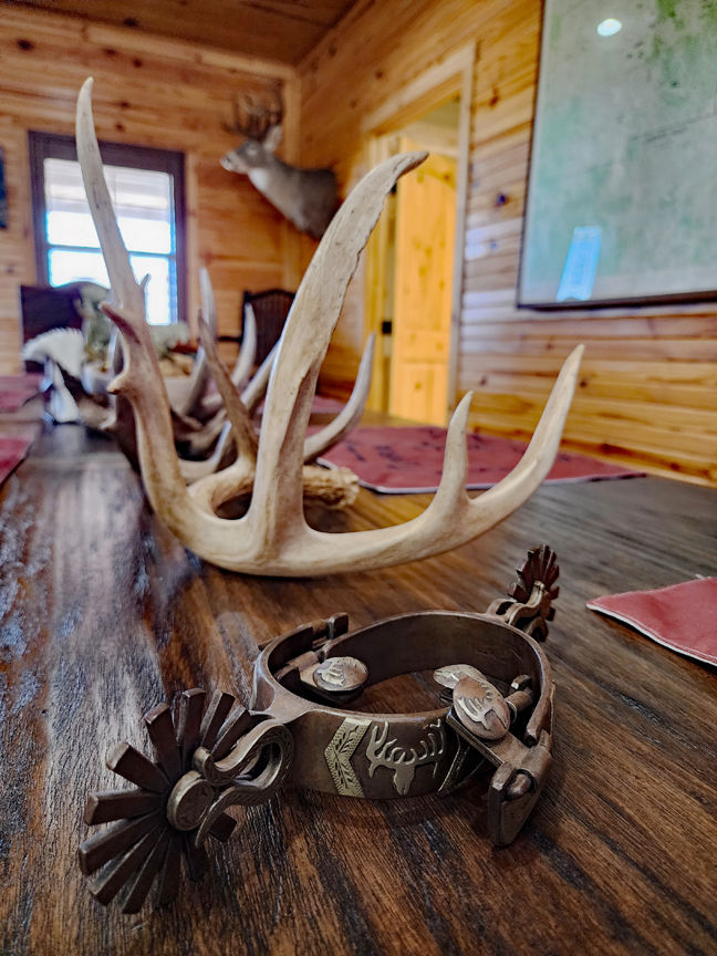 Antlers and spurs on ranch dining room table