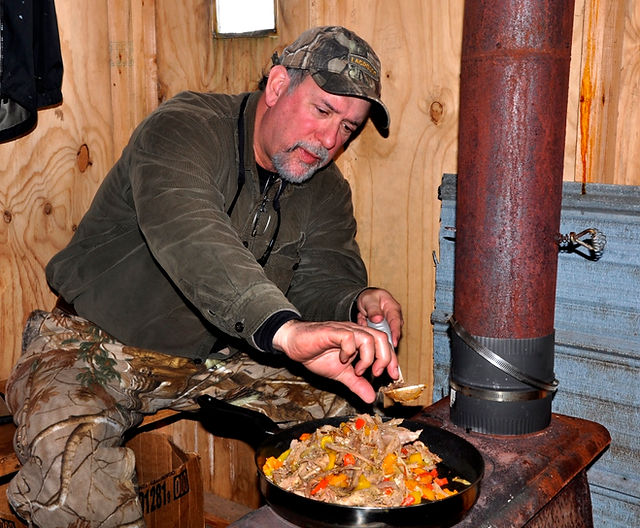 cooking wild hog fajitas in ice shanty-2