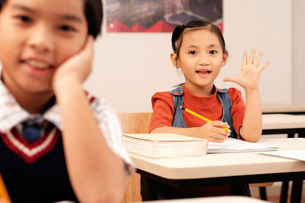 asian-pupils-sitting-classroom-girl-putting-up-hand-answer_edited.jpg