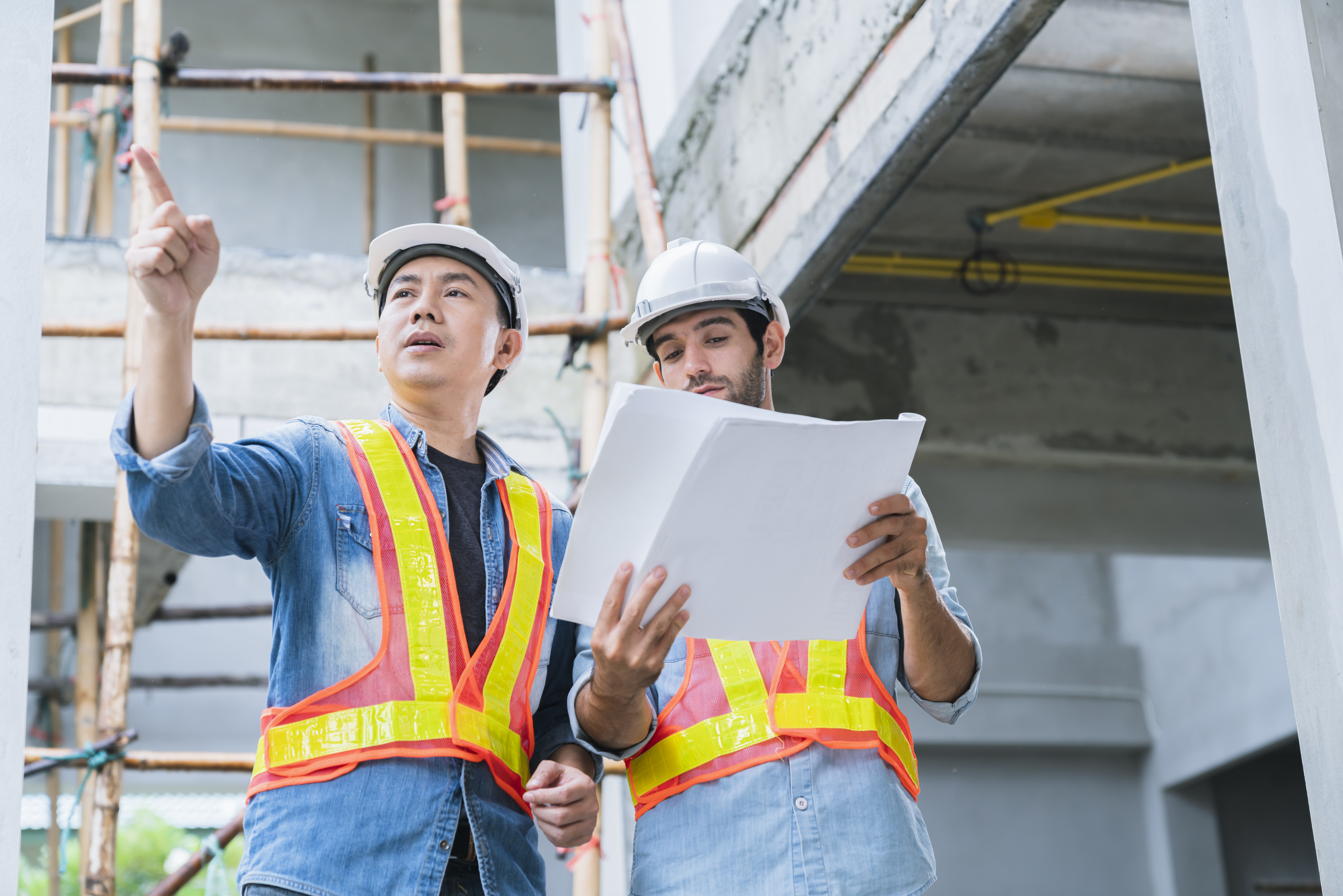young-asian-engineers-caucasian-engineer-colleagues-site-inspector-discuss-together-using-