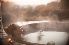 Lady relaxing in steaming hot tub