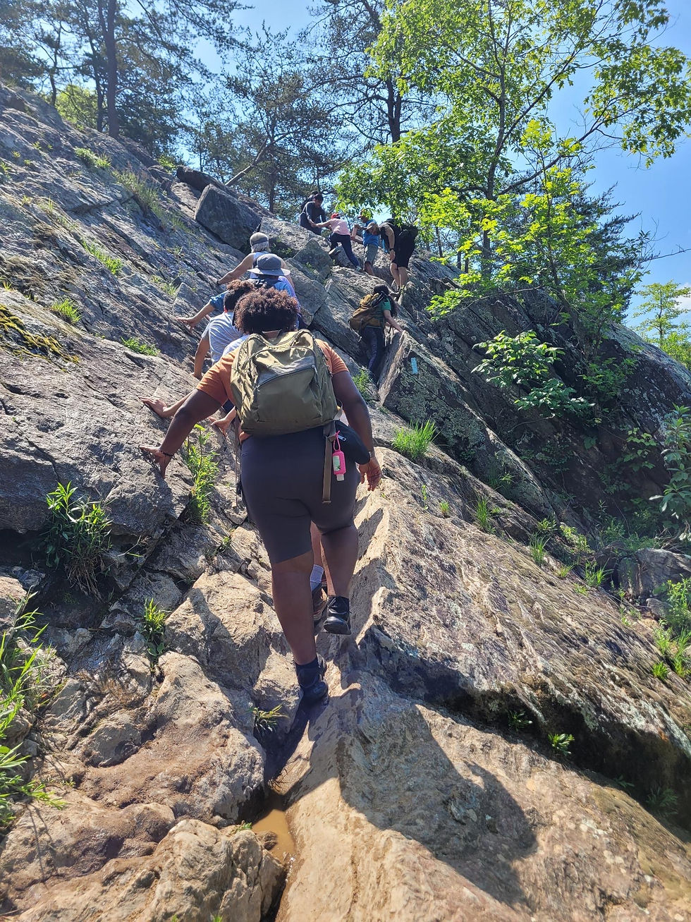 Bouldering up a cliff on the B/O Canal Trail