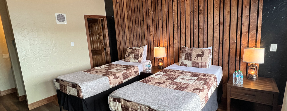 side bt side twin beds in one of the rooms at the lodge at sportsmans cove lodge where you rest and relax after a long day of deep sea fishing in alaska