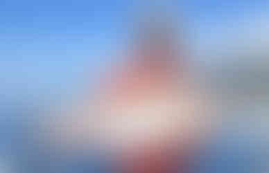 A guest at Sportsman's Cove Lodge holding up their salmon they caught themselves on a charter fishing trip