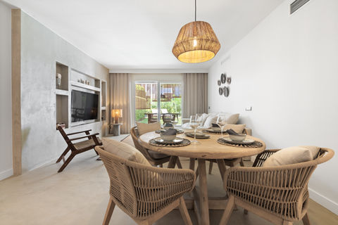 a dining room with a wooden table and chairs