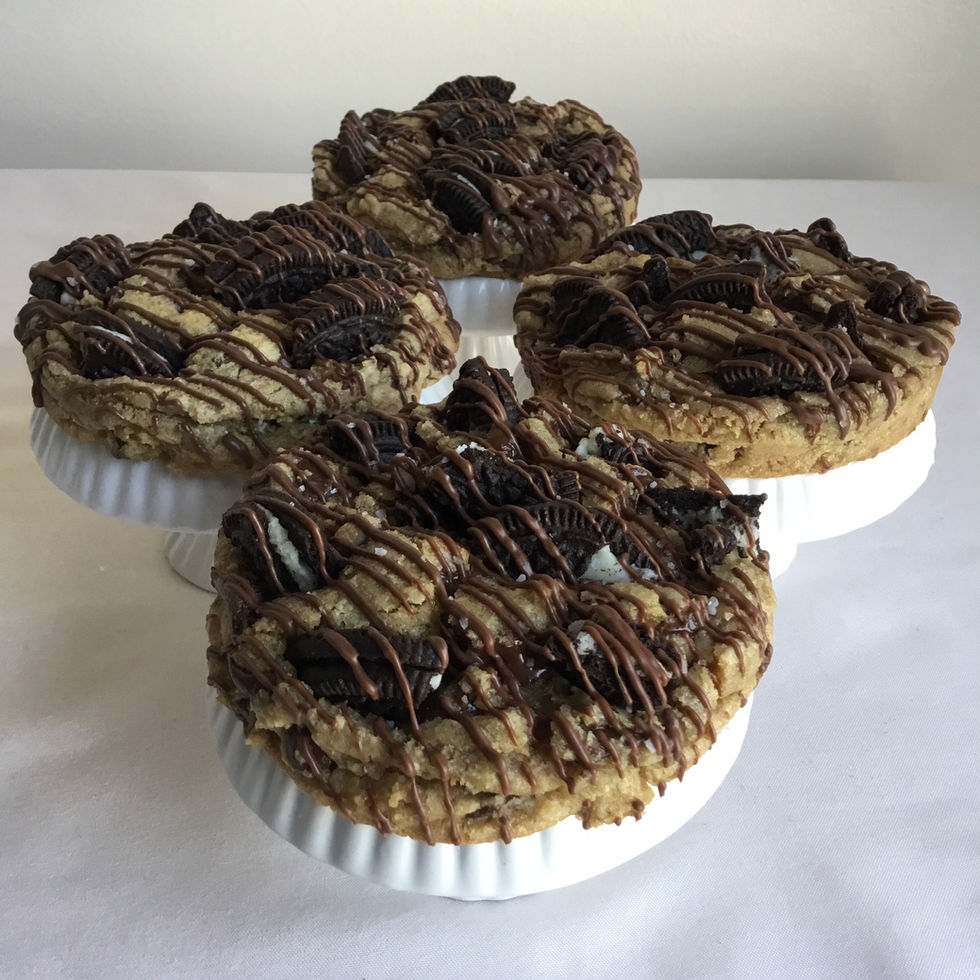 Thick chocolate chip cookies with Oreo cookie pieces and chocolate drizzle